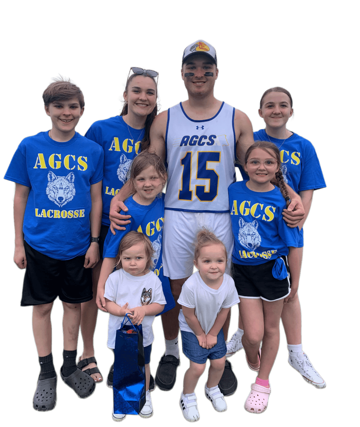 Family wearing custom blue 'AGCS Lacrosse' team t-shirts printed by Print Habit at a youth lacrosse game