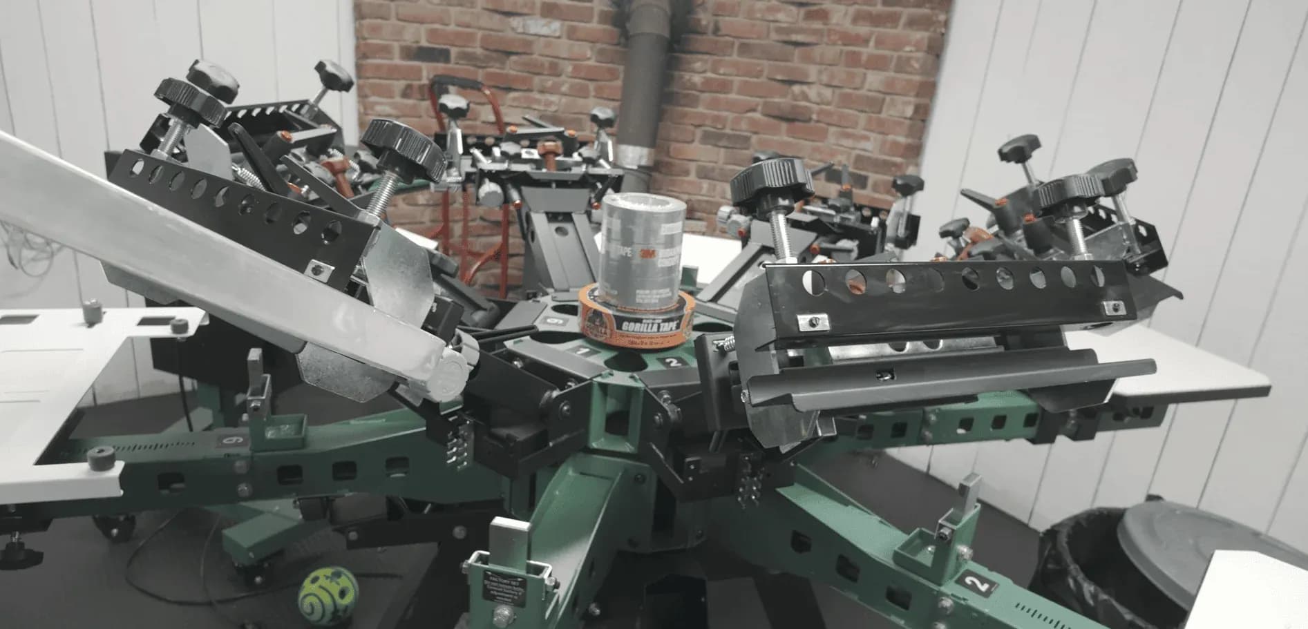 Press operator running a custom screen printing job at Print Habit in Coatesville, PA