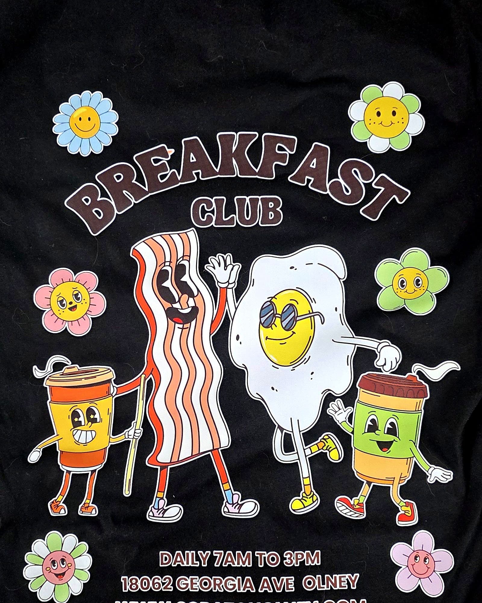 Full-color illustrated back print on a black staff t-shirt