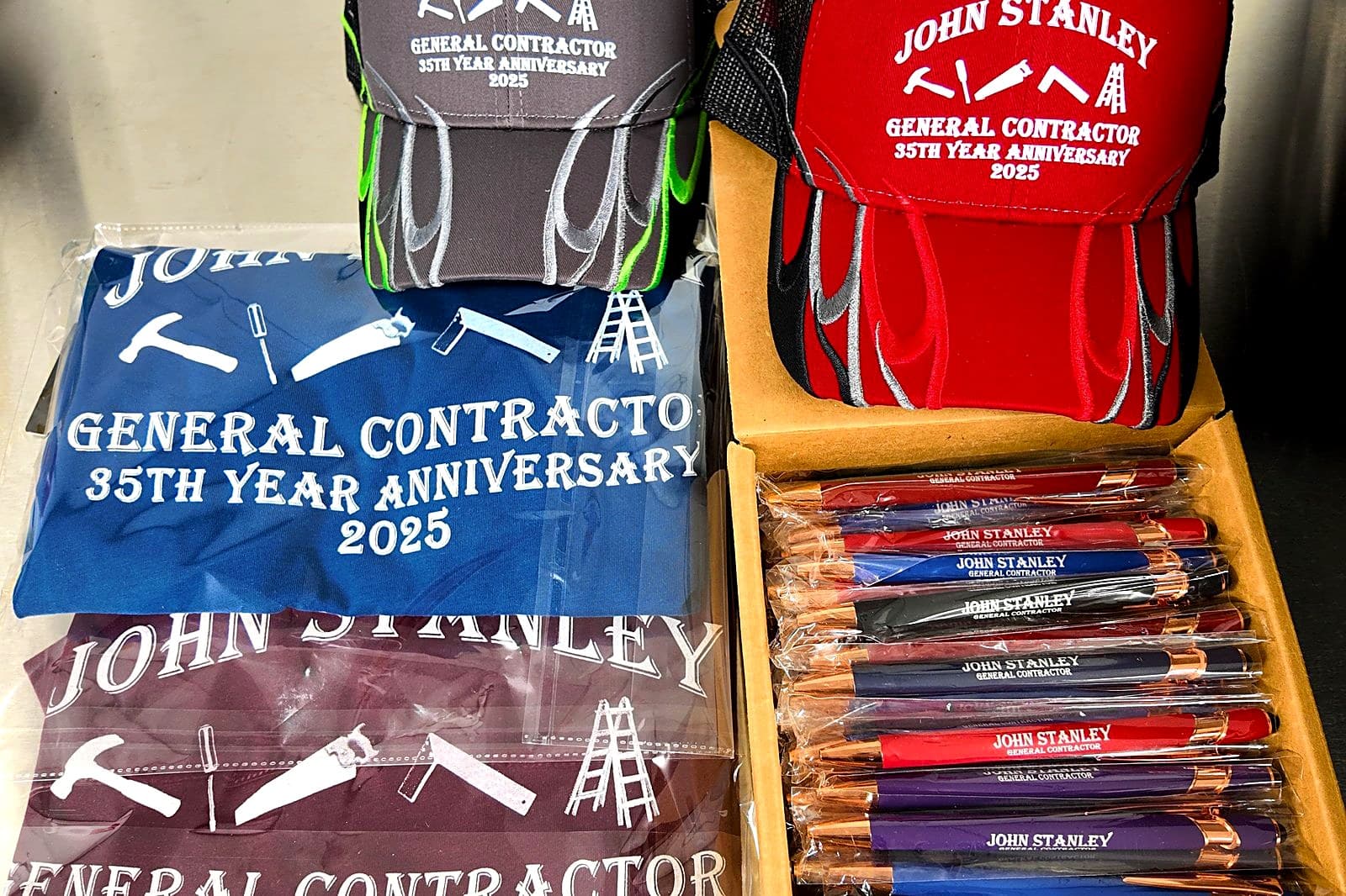 Custom t-shirts, hats and pens bagged and packed for a business order
