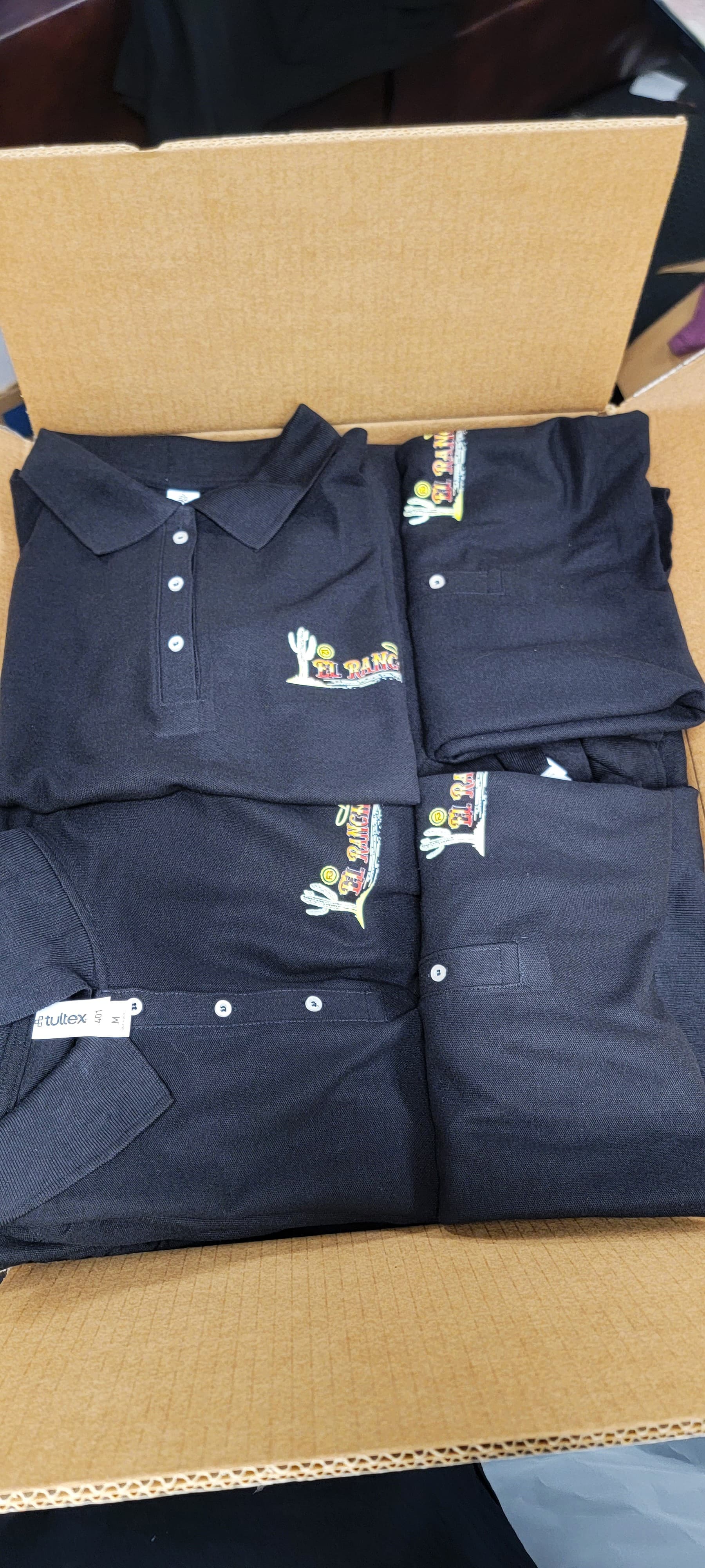 Boxed order of custom El Rancho staff polos ready for delivery by Print Habit