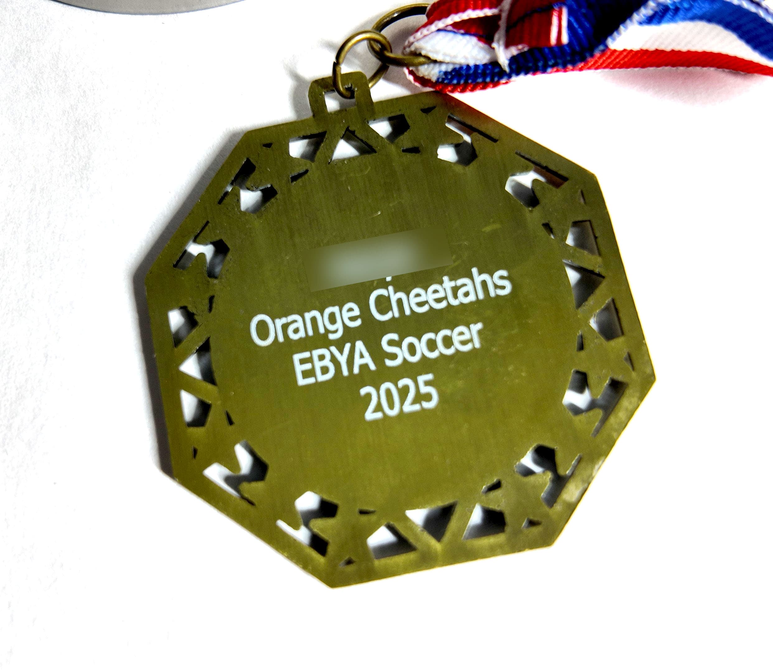 Laser-engraved personalized soccer medal back with team name, league, and player name by Print Habit
