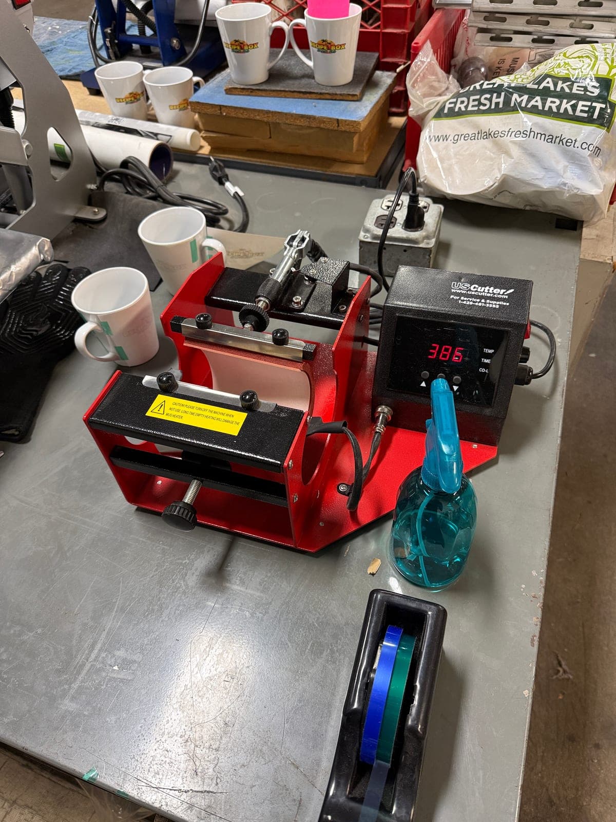 Red mug press heated to 385°F, set up to press sublimation transfers onto mugs