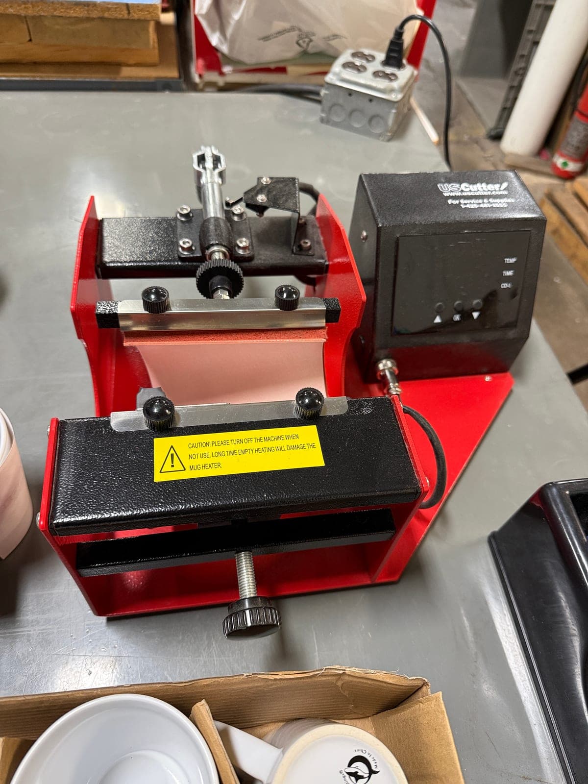 Close-up of the mug press Sonscreens uses to apply sublimation transfers