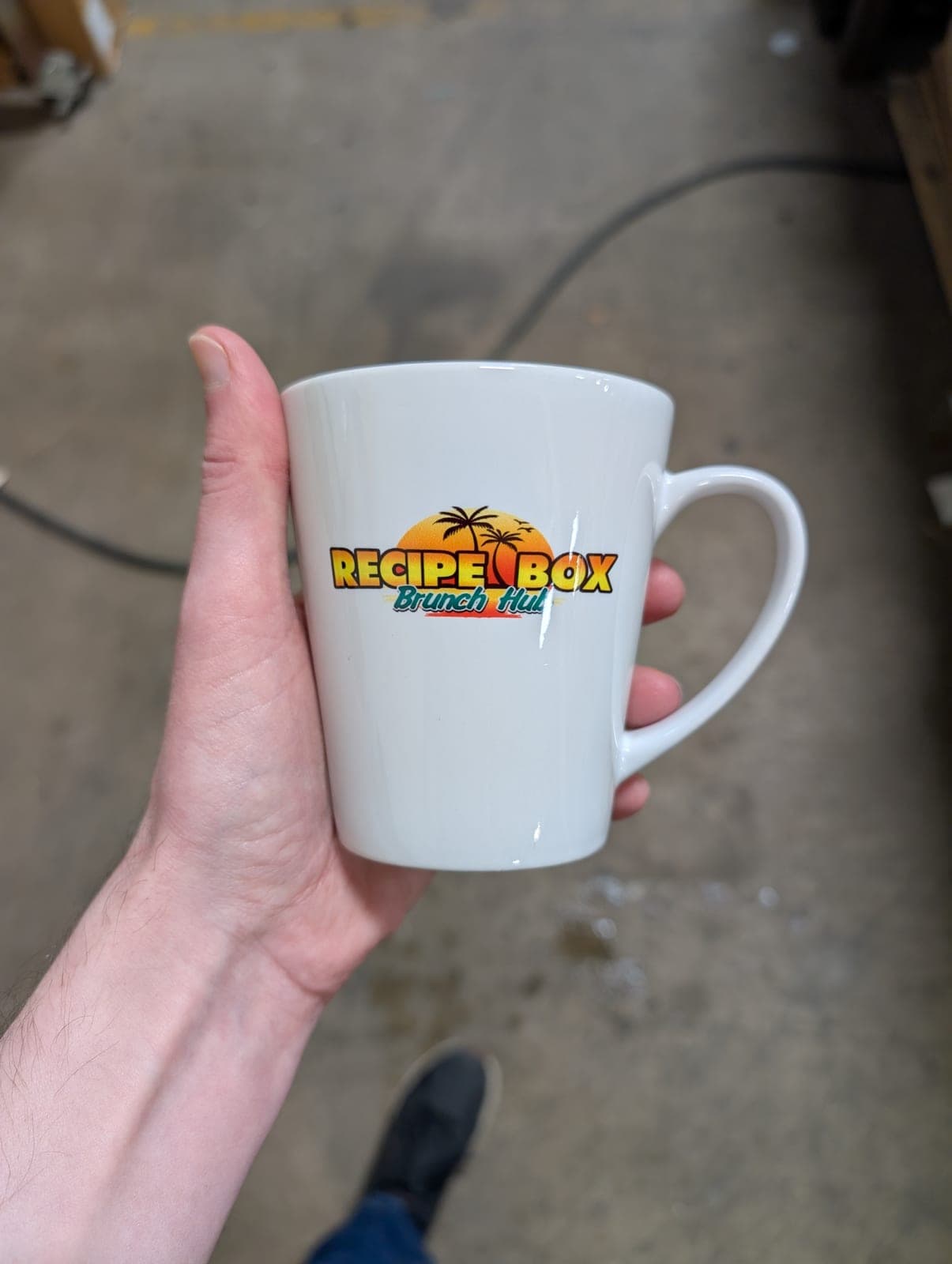 White latte mug with the full-color Recipe Box Brunch Hub logo, pressed by Sonscreens with a Print Habit sublimation transfer