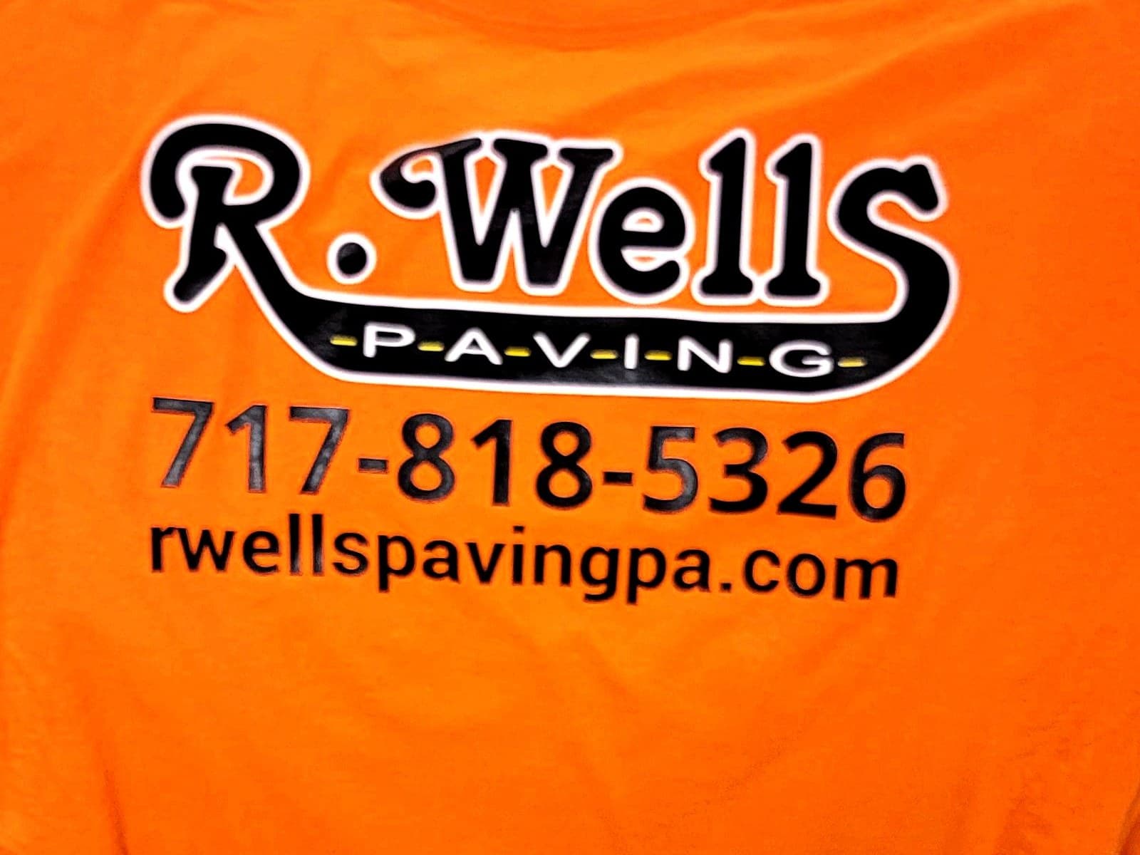 Safety orange t-shirt with a two-color paving company logo