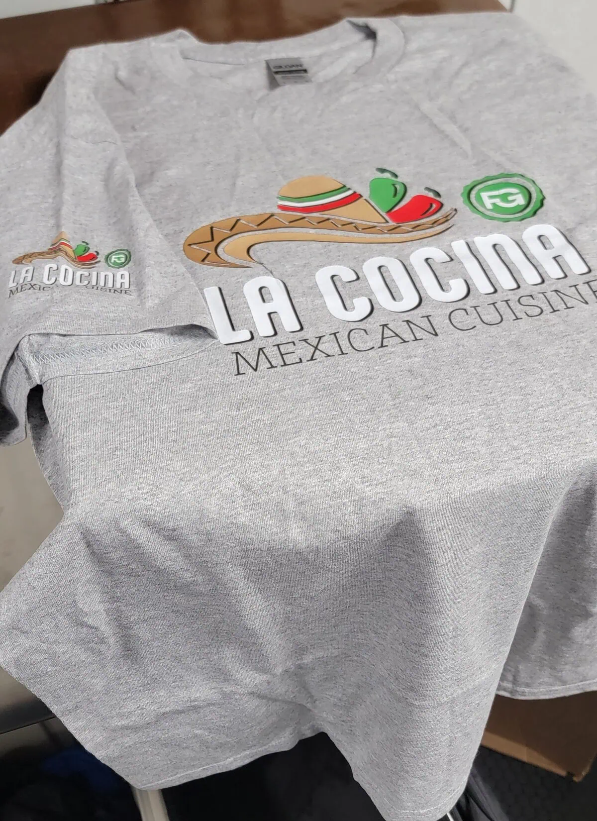 Image of custom t-shirt printing applied to a local business t-shirt