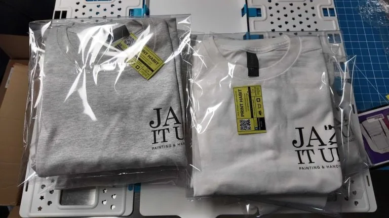 Custom screen printing Coatesville image with a box of custom screen printed t-shirts