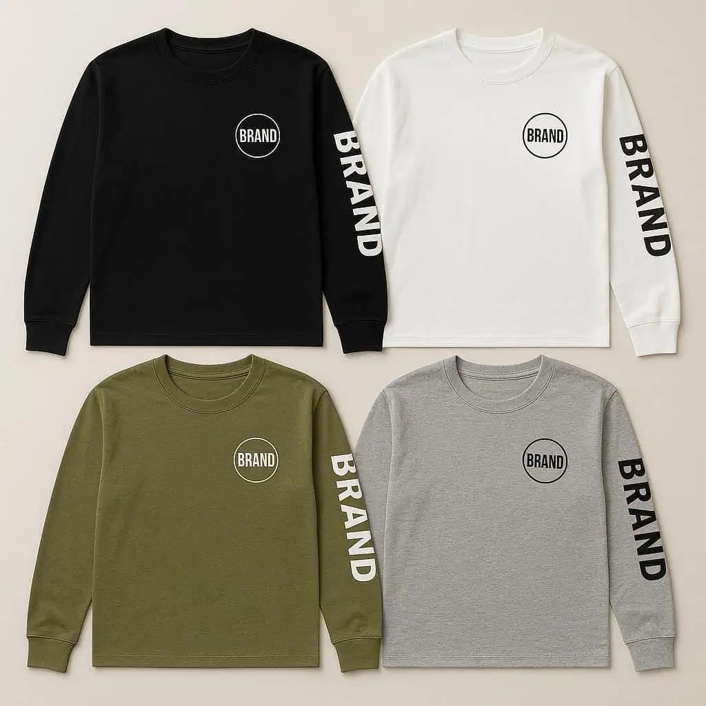 Flat lay of four long sleeve t-shirts in white, black, olive green, and heather gray, each with a chest logo and sleeve print, displayed on a neutral fabric background.